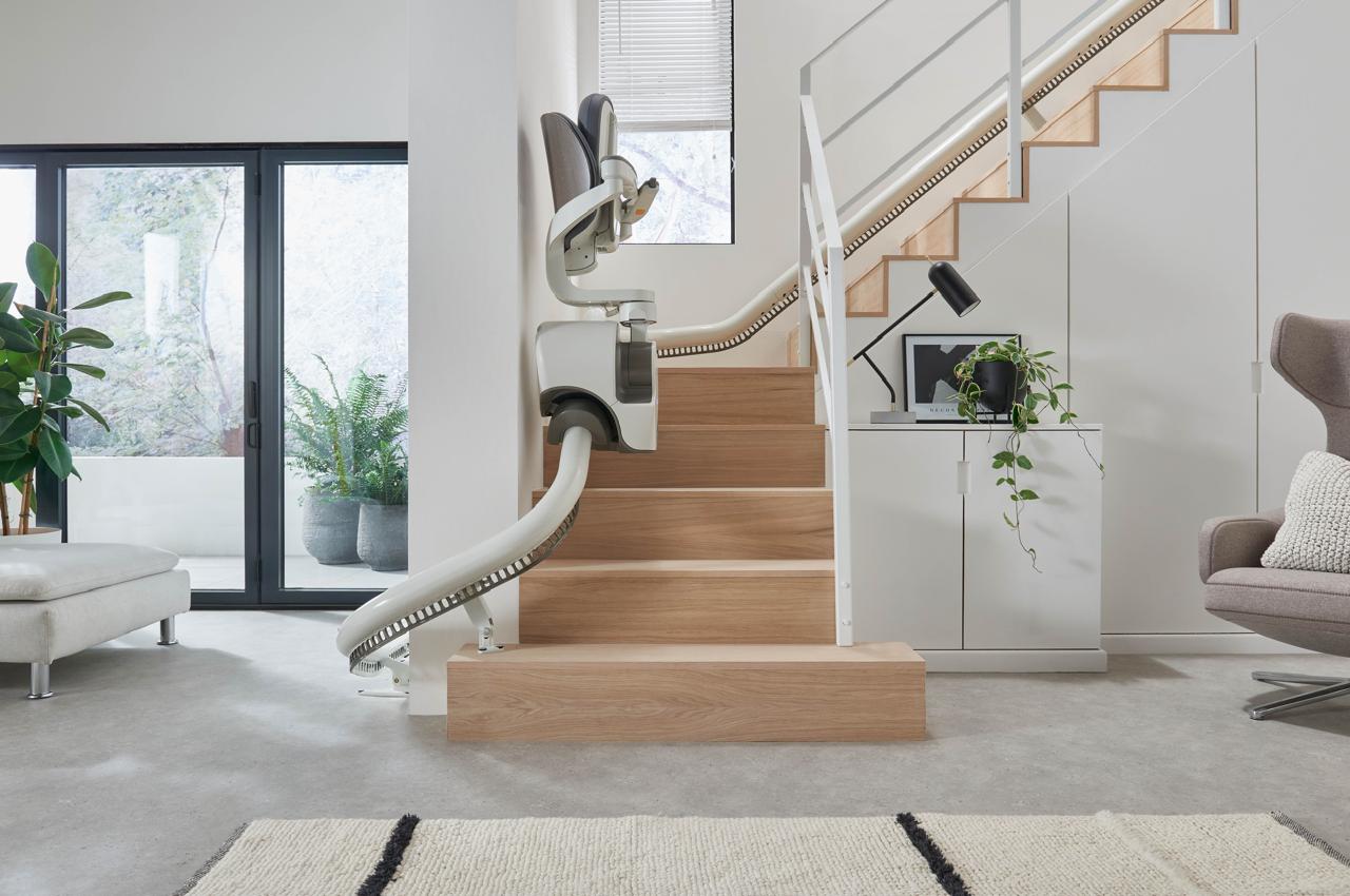 A stairlift installed on a wooden staircase in a home.